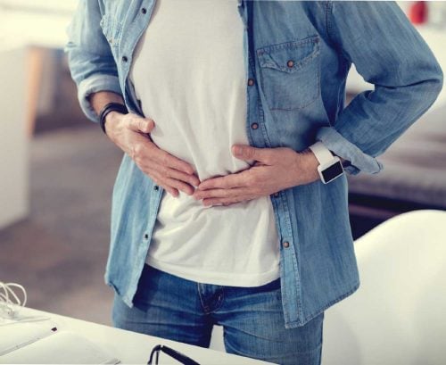 Man holding sore stomach