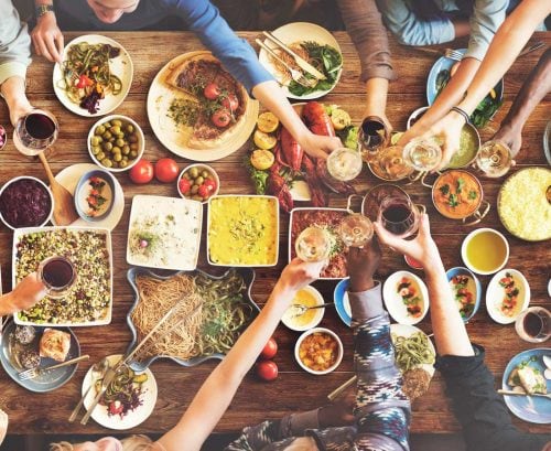 People eating Med-style food at a table