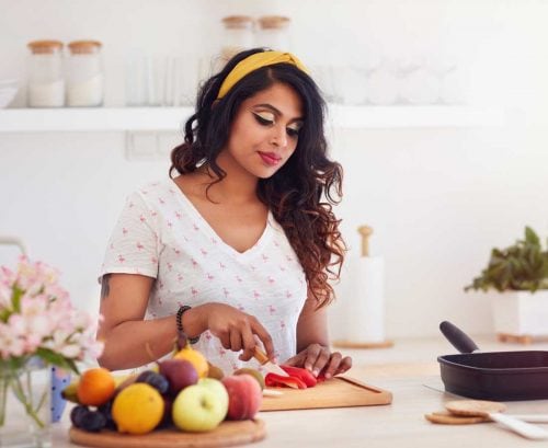 Woman chopping vegetables in kitchen