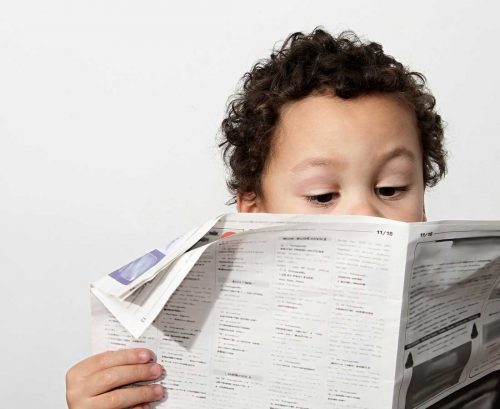 Kid reading the paper