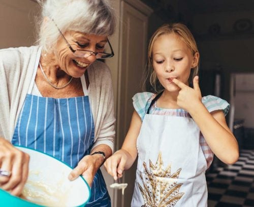 Grandmother cooking with grand daughter