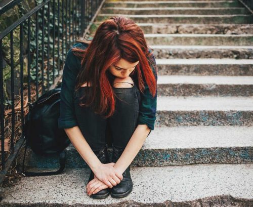 Teen girls on steps looking depressed