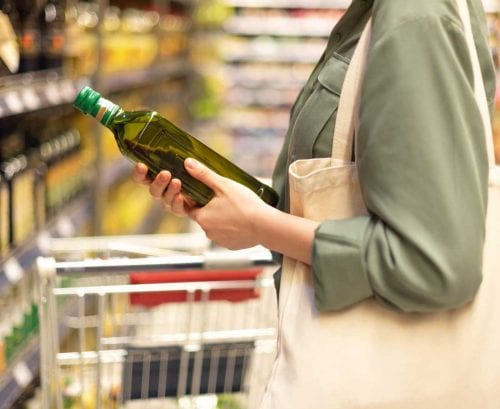 Woman shopping for cooking oil