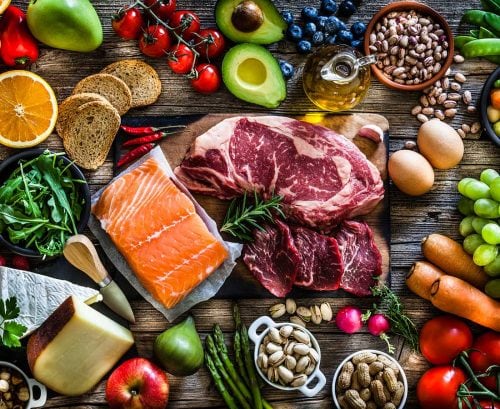 an array of vegetables, fruit, nuts, legumes, fish and meat