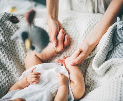 Mother holding baby's feet