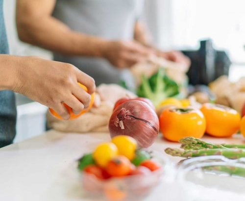 Two people chopping vegetables