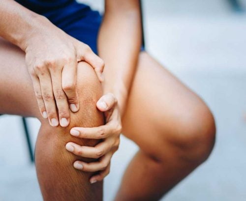 Man holding his sore knee
