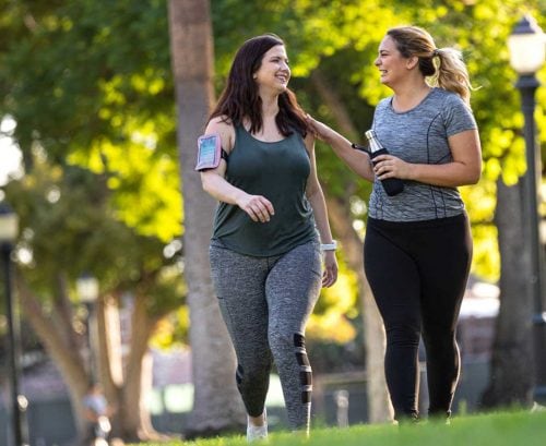 Two women walking in the park