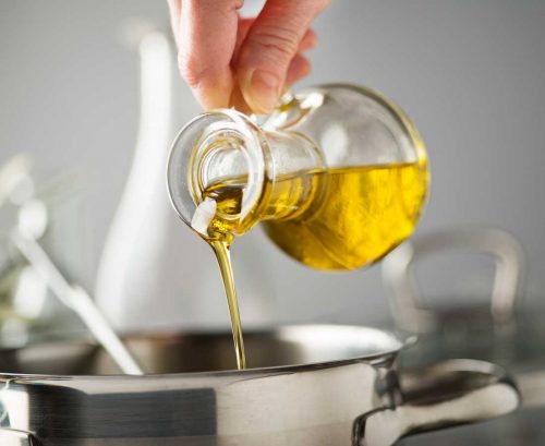 Cooking oil being poured into a pot