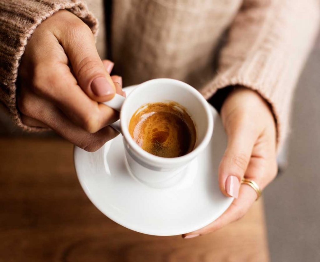 Alcohol, caffeine and sleep Woman holding a cup of coffee