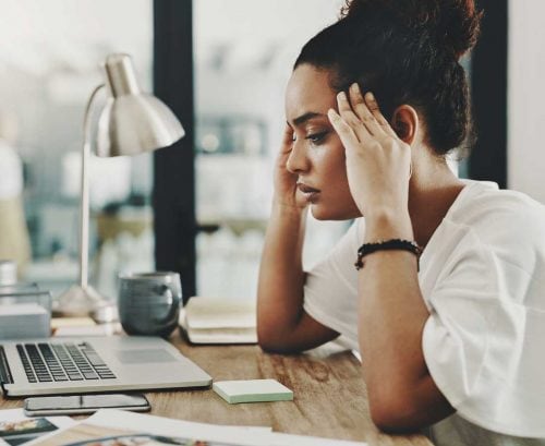 Woman at her desk looking burnt out