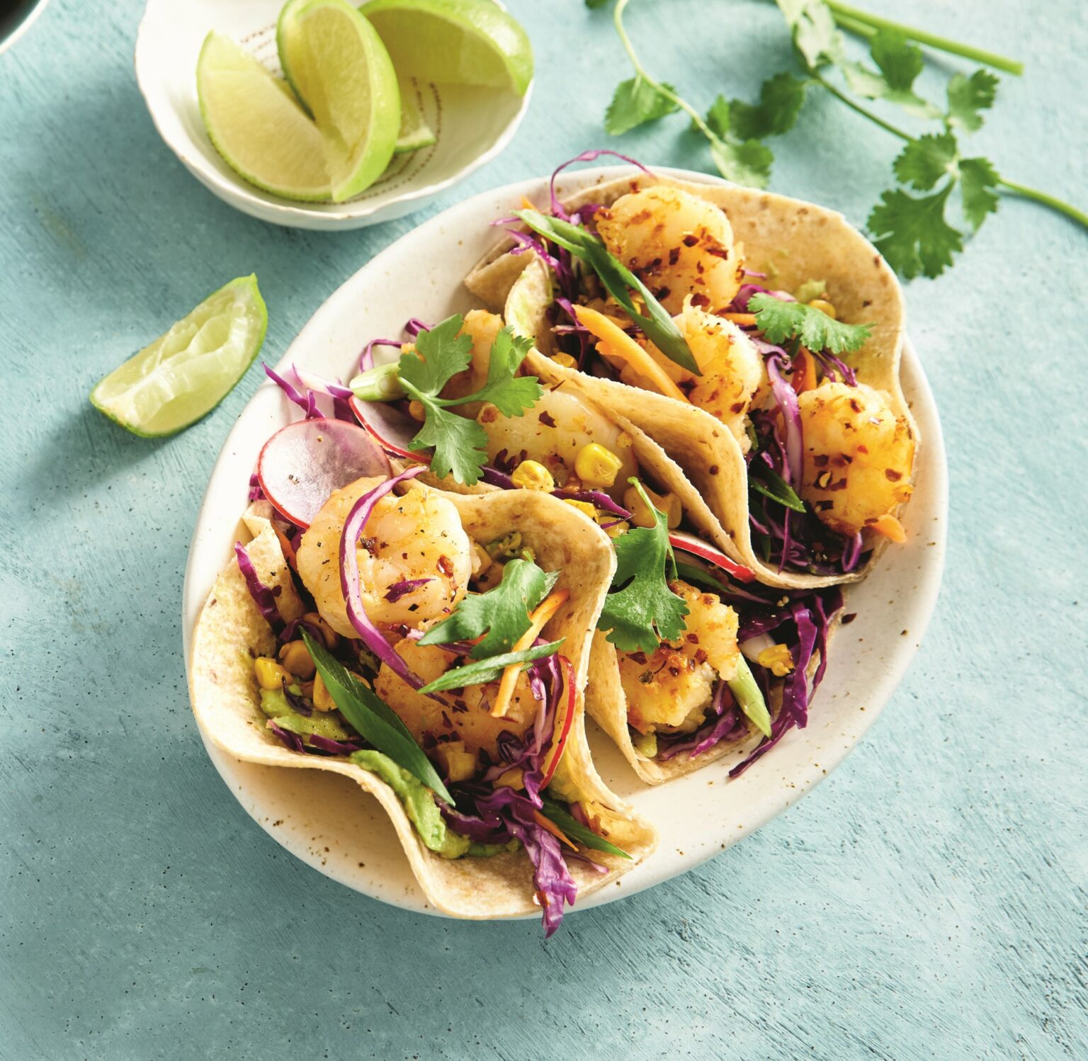 Prawn tacos with charred corn, cabbage and avocado