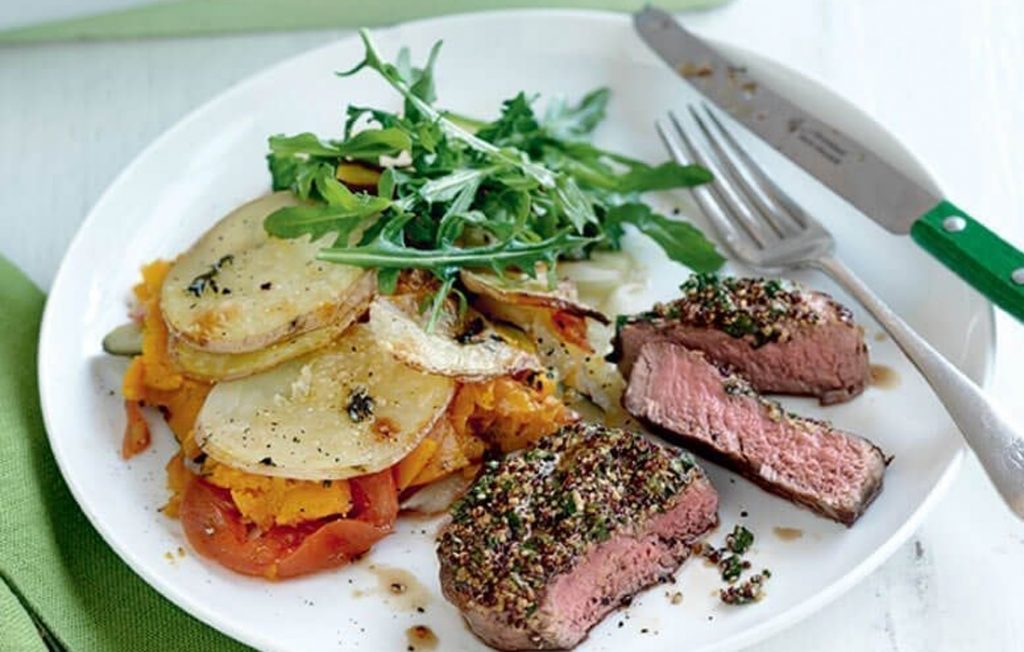 Mustard steaks with layered vegetable bake