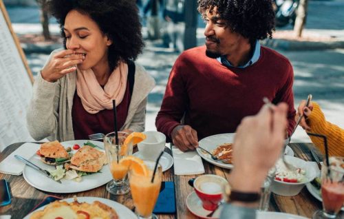 Friends eating breakfast together at a cafe