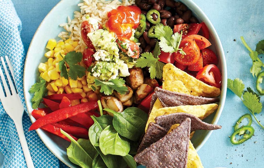 Black bean and mushroom burrito bowls topped with fully loaded guacamole