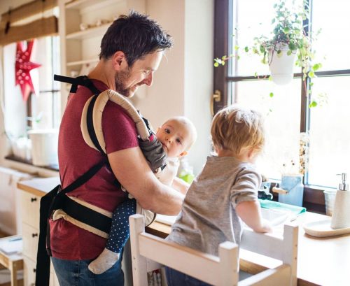 Man with baby and child doing the dishes
