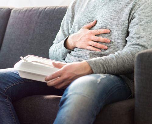 Man holding his stomach after eating