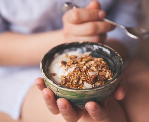 Woman eating toasted oats/muesli