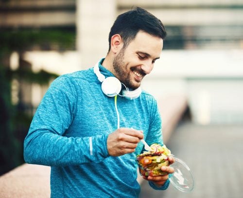 Man eating a salad breaking his fast