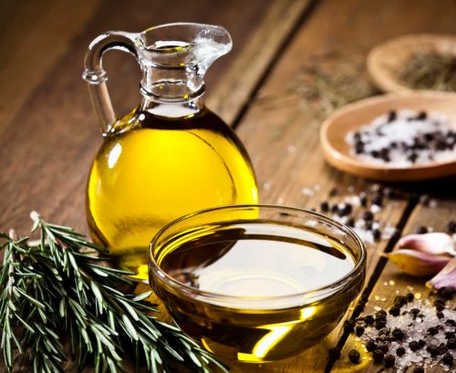a glass jug and small bowl of olive oil