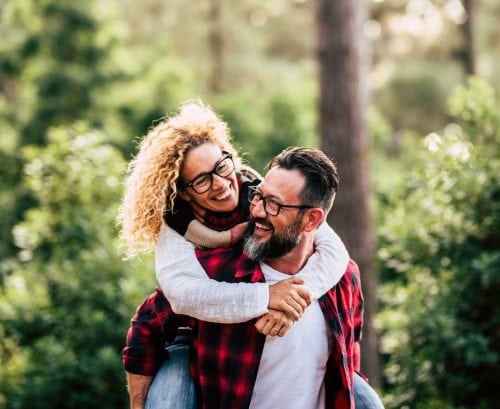 Middle-aged couple playing and laughing