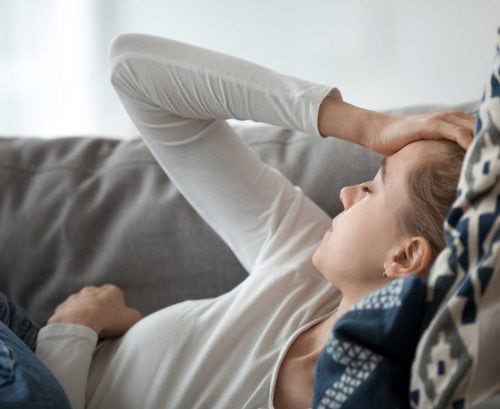 Fatigued woman lying on couch