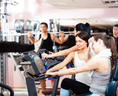 People working out in a busy gym