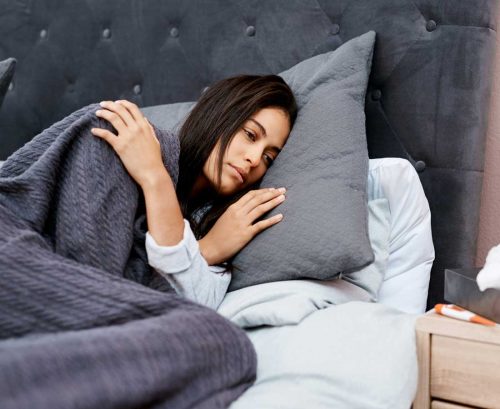 Woman in bed, sick