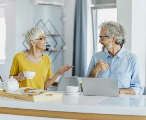 Healthy older couple chatting over breakfast