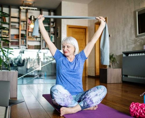 Woman doing resistance band training at home