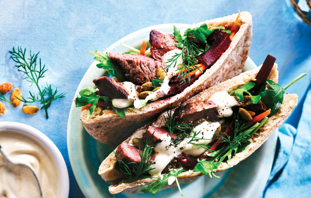 Pita pockets with seared beef and beetroot and pumpkin seed salad