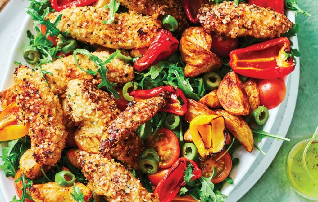 Crumbed chicken with roasted potato, tomato and olive salad