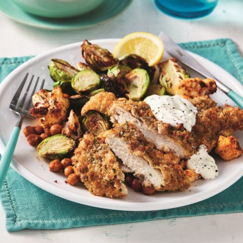 Air-fryer rosemary and rye crumbed chicken schnitzel with crispy Brussels sprouts