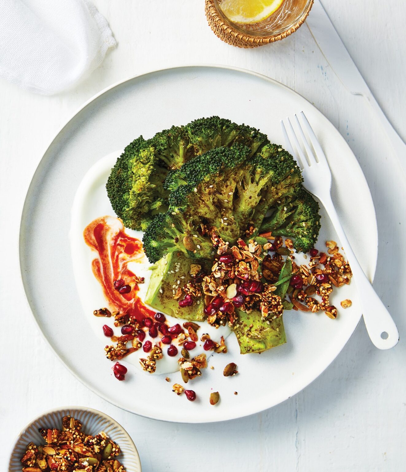 Broccoli steaks with harissa yoghurt and savoury granola
