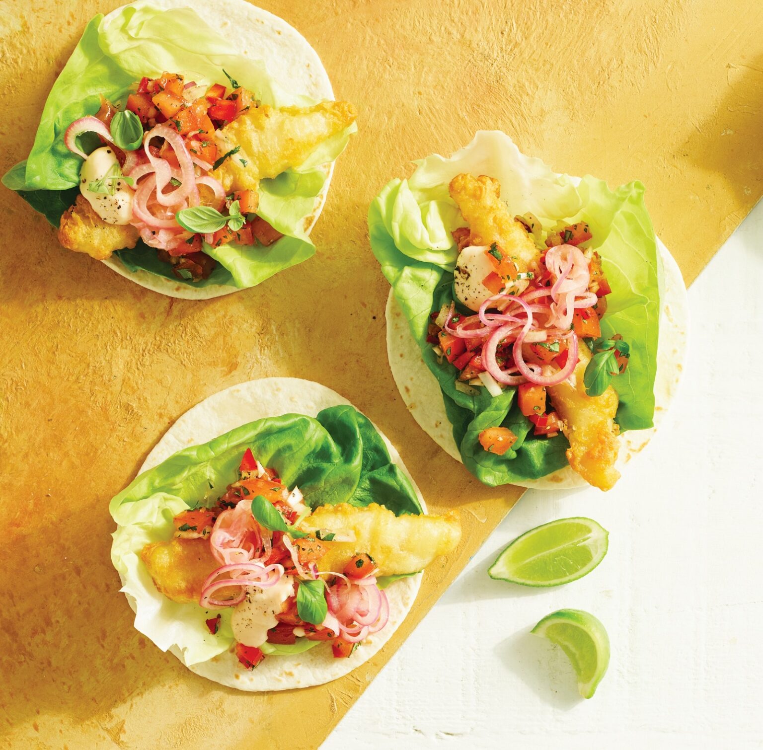 Fish tacos with pink pickled onions and tomato salsa