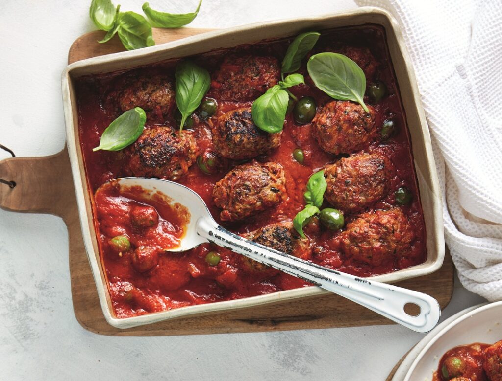 Baked lamb meatballs with tomatoes, olives and couscous